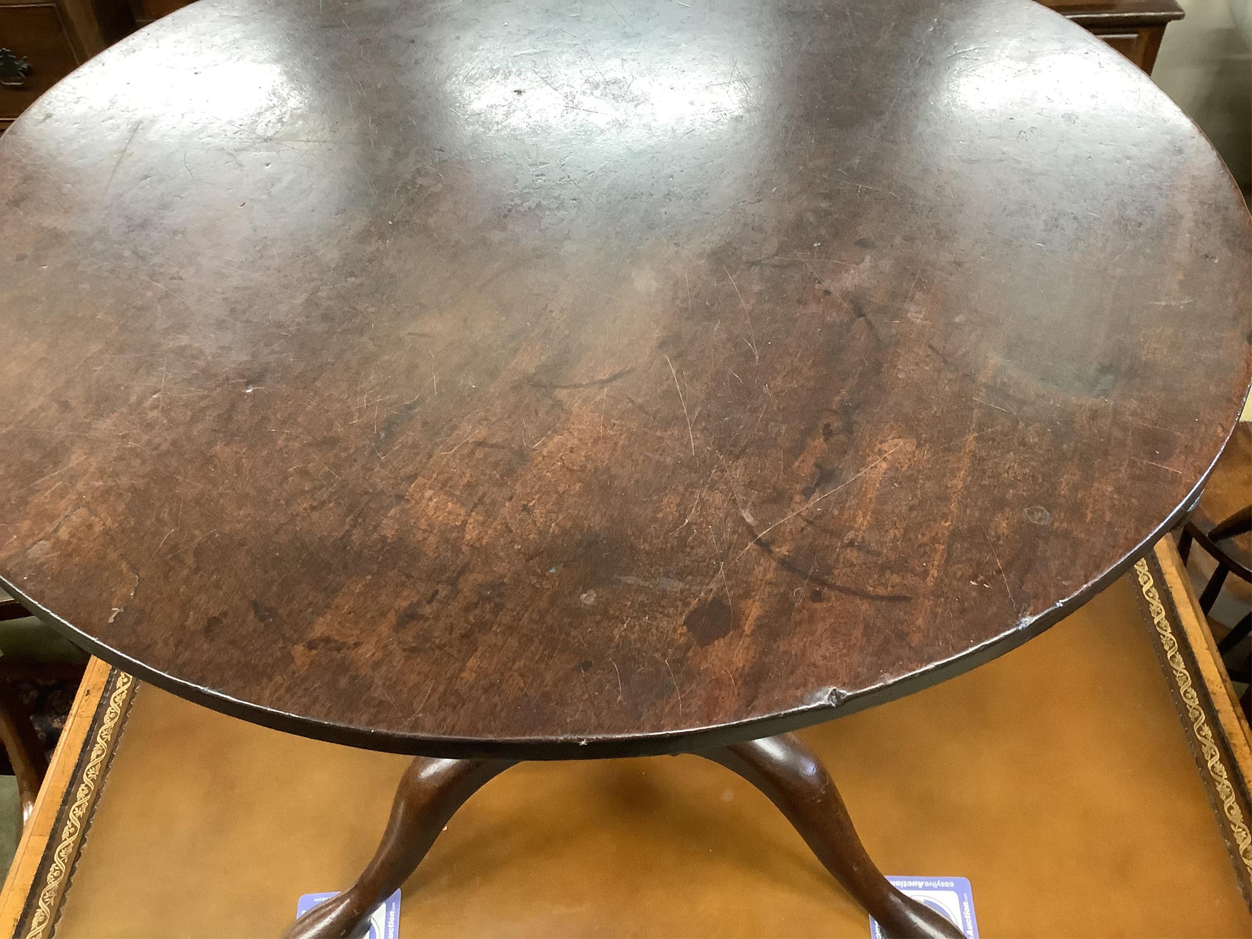 A George III circular mahogany tilt top bird cage tripod tea table, diameter 69cm, height 69cm. Condition - fair